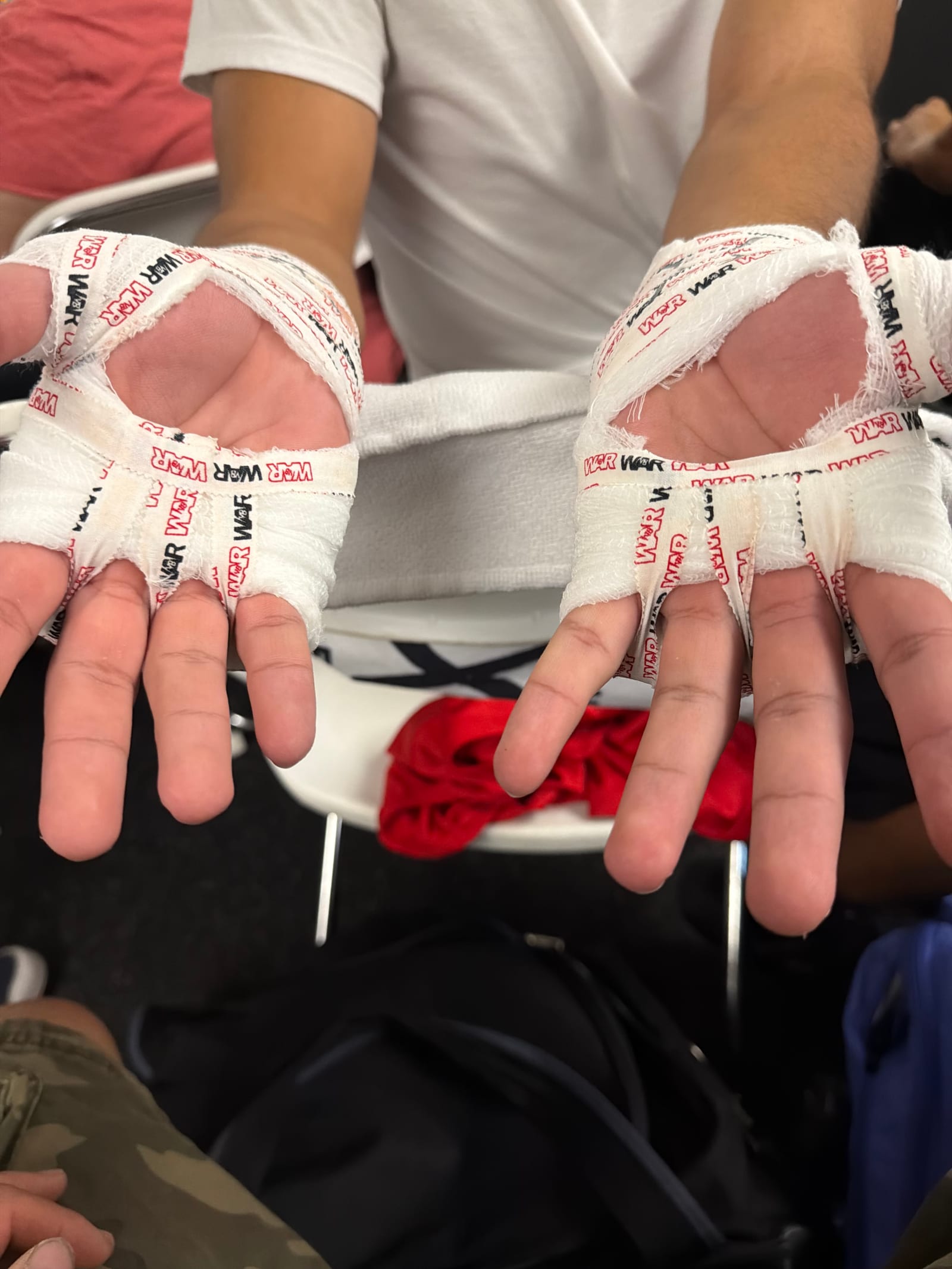 An Ironhand fighter's completed gauze and tape wraps, palms up, before the gloves go on